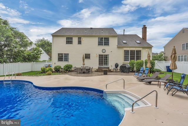 view of swimming pool featuring a fenced backyard, a patio, and entry steps