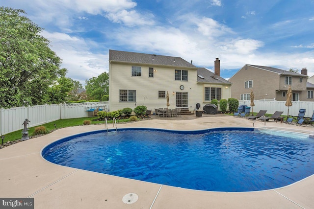 view of pool featuring a patio, a fenced backyard, and entry steps