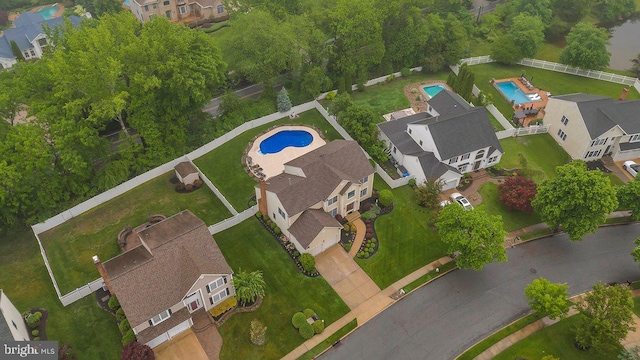 view of property location featuring a pool and nearby suburban area
