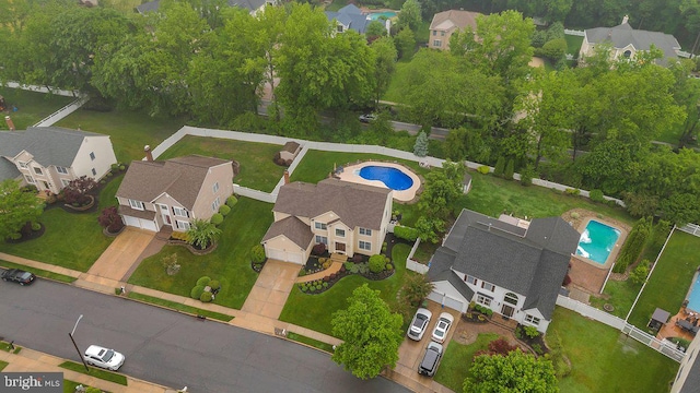 aerial view of property's location with a pool area and nearby suburban area