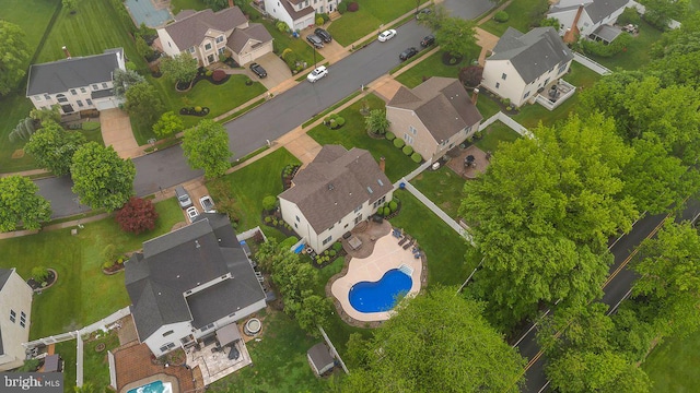 aerial perspective of suburban area featuring a pool area