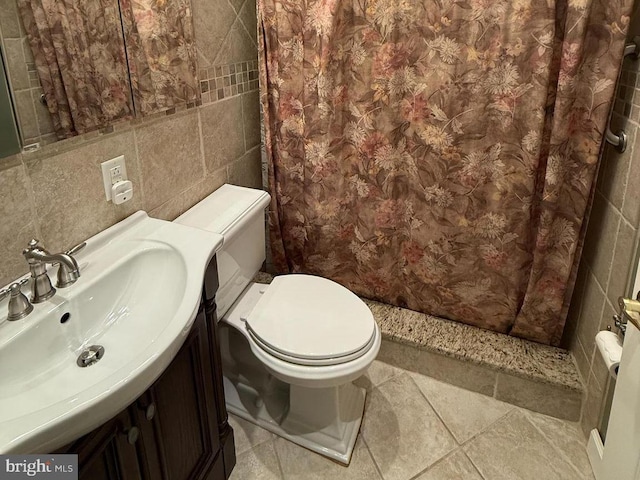 bathroom featuring tile walls, toilet, curtained shower, and vanity