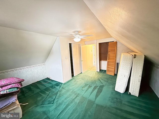 bonus room with vaulted ceiling, carpet flooring, and ceiling fan