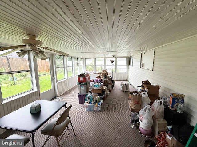 sunroom featuring healthy amount of natural light and ceiling fan