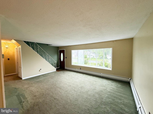 unfurnished living room with carpet flooring, a baseboard heating unit, a textured ceiling, and baseboards