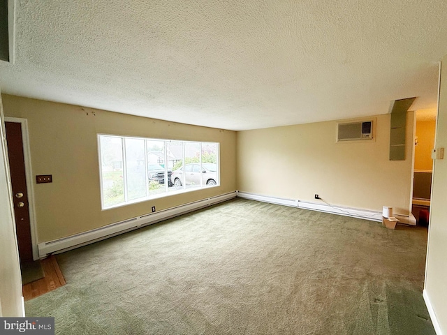 empty room with a textured ceiling, a baseboard radiator, an AC wall unit, and carpet floors