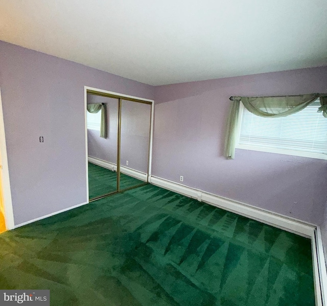unfurnished bedroom with carpet floors, a closet, and baseboards