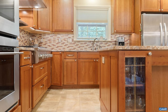 2657 Coralberry Pl, Charlottesville, VA 22911 - kitchen featuring stainless steel oven, tasteful backsplash, a sink, and light tile patterned floors