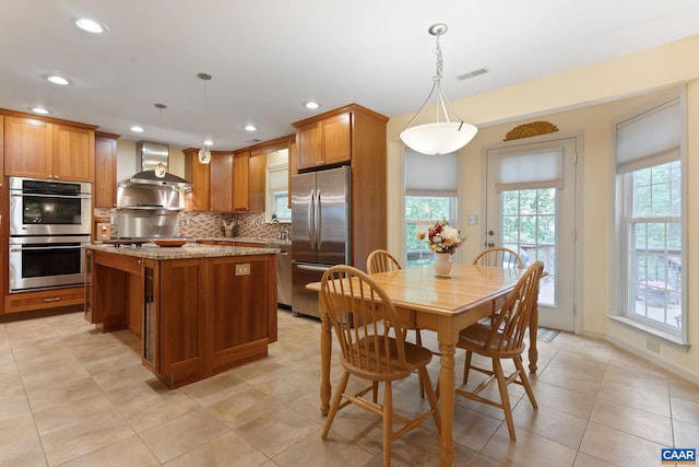 2657 Coralberry Pl, Charlottesville, VA 22911 - kitchen featuring appliances with stainless steel finishes, wall chimney exhaust hood, backsplash, plenty of natural light, and recessed lighting