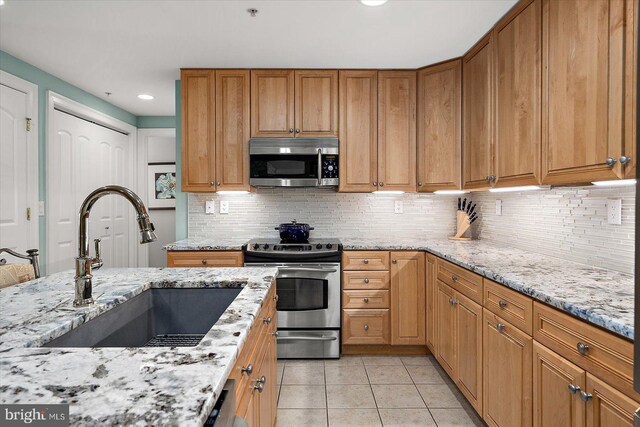 301 14th St Unit 308/309, Ocean City, MD 21842 - kitchen with stainless steel appliances, a sink, light tile patterned floors, light stone counters, and recessed lighting