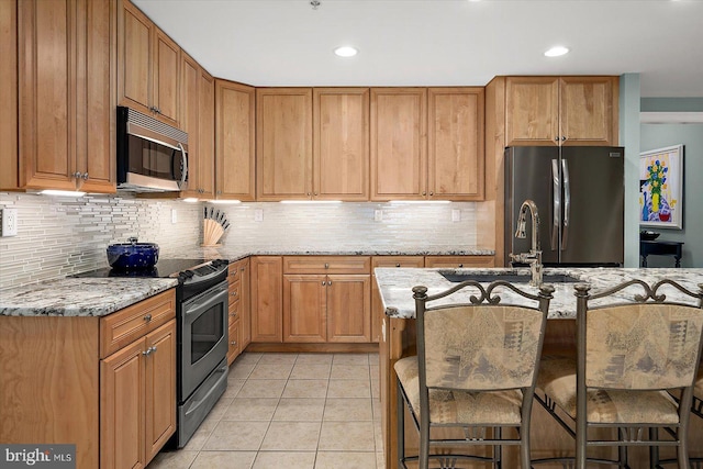 301 14th St Unit 308/309, Ocean City, MD 21842 - kitchen featuring appliances with stainless steel finishes, light tile patterned floors, light stone counters, tasteful backsplash, and recessed lighting