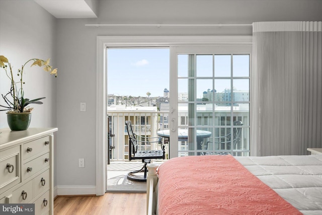 301 14th St Unit 308/309, Ocean City, MD 21842 - bedroom featuring access to exterior, light wood-type flooring, and baseboards