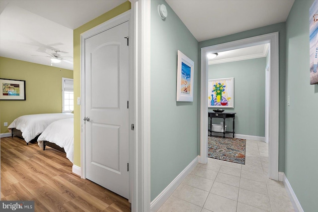 301 14th St Unit 308/309, Ocean City, MD 21842 - corridor with baseboards, light tile patterned flooring, and ornamental molding