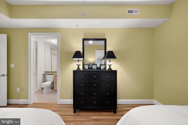 301 14th St Unit 308/309, Ocean City, MD 21842 - bedroom featuring wood finished floors, baseboards, and ensuite bath