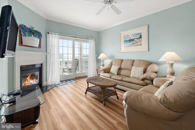 301 14th St Unit 308/309, Ocean City, MD 21842 - living area with a ceiling fan, wood finished floors, ornamental molding, and a fireplace