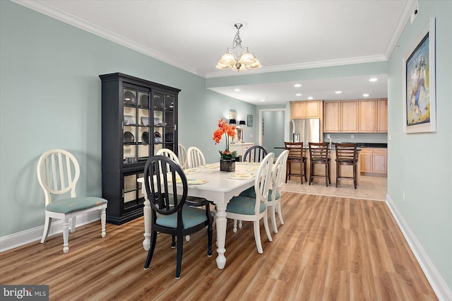 301 14th St Unit 308/309, Ocean City, MD 21842 - dining area featuring light wood-type flooring, a chandelier, crown molding, baseboards, and recessed lighting