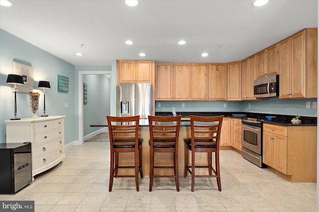 301 14th St Unit 308/309, Ocean City, MD 21842 - kitchen featuring stainless steel appliances, light tile patterned floors, recessed lighting, a kitchen breakfast bar, and dark countertops