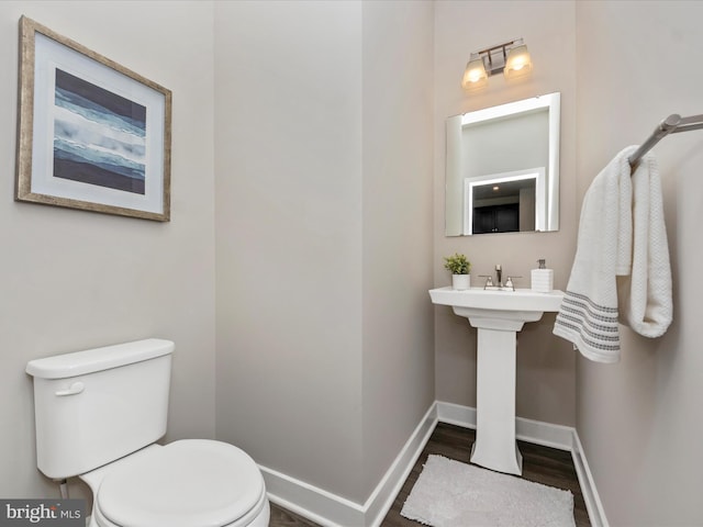 14716 Spring Haven Ln, Laurel, MD 20707 - half bathroom featuring toilet, baseboards, and wood finished floors