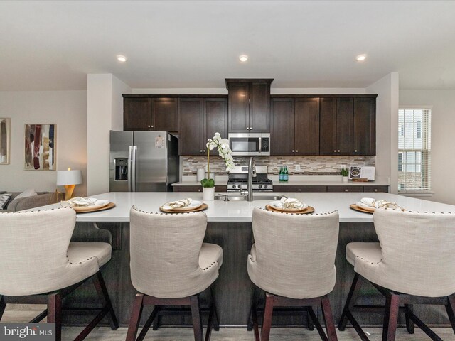 14716 Spring Haven Ln, Laurel, MD 20707 - kitchen with stainless steel appliances, tasteful backsplash, light countertops, and dark brown cabinetry