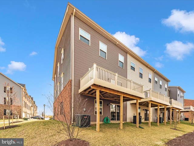 14716 Spring Haven Ln, Laurel, MD 20707 - back of house with cooling unit, a wooden deck, and a lawn