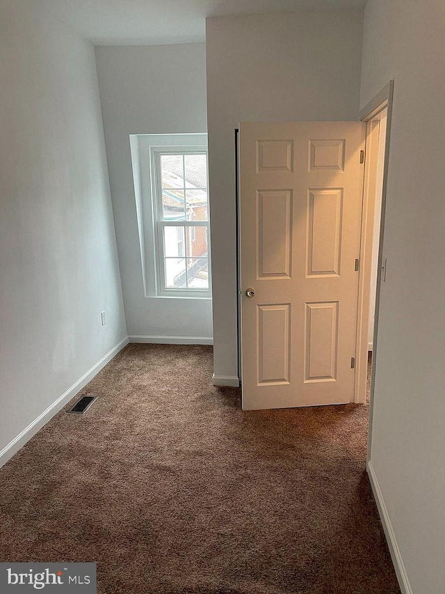 unfurnished bedroom with carpet flooring and baseboards