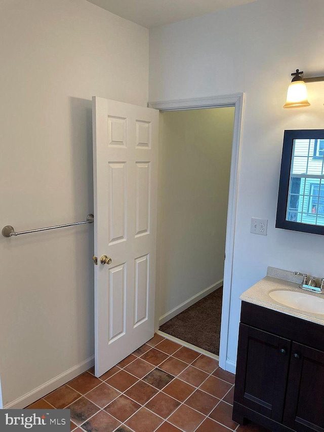 bathroom featuring tile patterned flooring, vanity, and baseboards