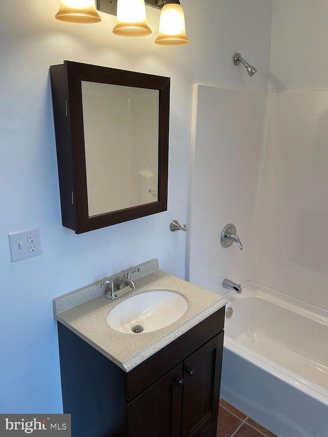 full bathroom with vanity, washtub / shower combination, and tile patterned flooring