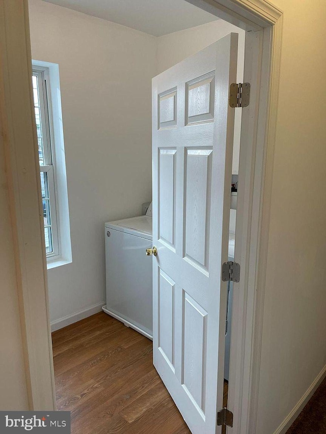 laundry room featuring wood finished floors, washer / clothes dryer, baseboards, and plenty of natural light
