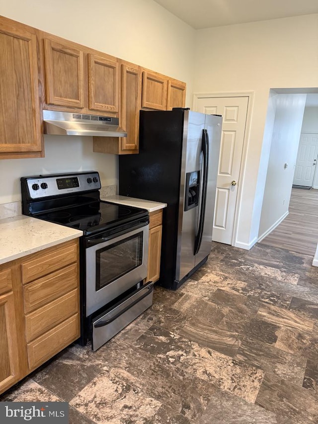 kitchen with stainless steel appliances, under cabinet range hood, and brown cabinets