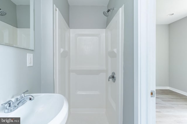 1632 N Sydenham St, Philadelphia, PA 19121 - bathroom featuring a sink, a shower, wood finished floors, and baseboards