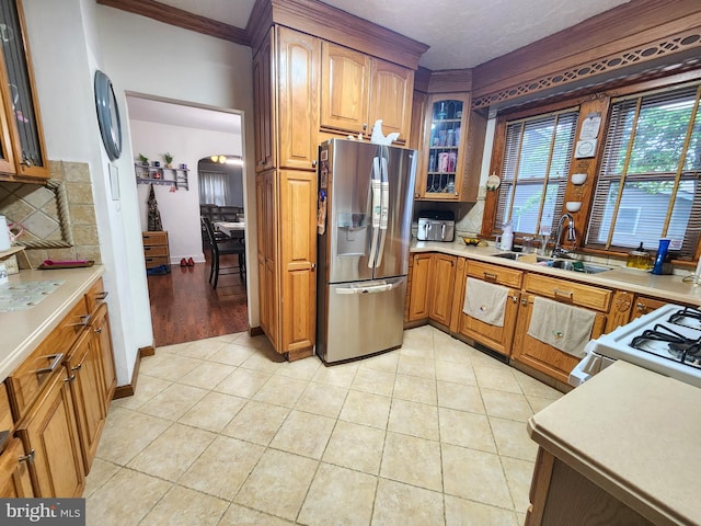 35 W Montrose St, Vineland, NJ 08360 - kitchen with stainless steel fridge with ice dispenser, a sink, glass insert cabinets, light countertops, and crown molding