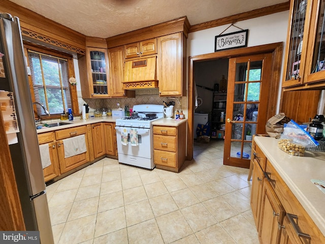 35 W Montrose St, Vineland, NJ 08360 - kitchen featuring white gas range, custom exhaust hood, freestanding refrigerator, tasteful backsplash, and light countertops