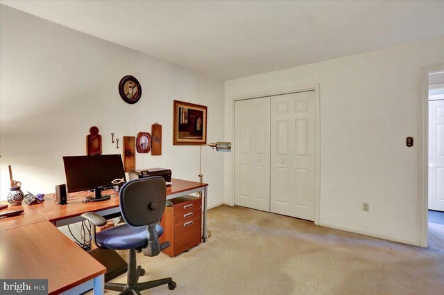office with light carpet and baseboards