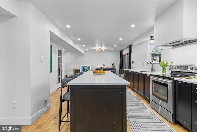 1745 Remington Dr, Crofton, MD 21114 - kitchen featuring electric range, a sink, recessed lighting, open floor plan, and a kitchen bar