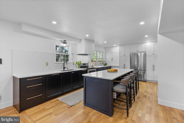 1745 Remington Dr, Crofton, MD 21114 - kitchen featuring appliances with stainless steel finishes, a sink, light countertops, a breakfast bar, and recessed lighting