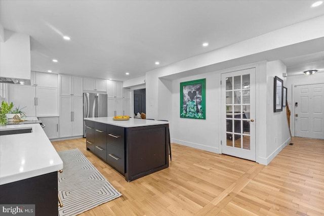 1745 Remington Dr, Crofton, MD 21114 - kitchen with light countertops, freestanding refrigerator, light wood-type flooring, white cabinetry, and recessed lighting