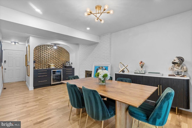 1745 Remington Dr, Crofton, MD 21114 - dining room with beverage cooler, a chandelier, light wood finished floors, and a dry bar
