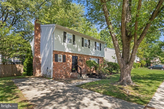 1745 Remington Dr, Crofton, MD 21114 - colonial house featuring a chimney, brick siding, and driveway