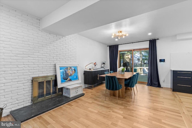 1745 Remington Dr, Crofton, MD 21114 - dining room featuring light wood-style floors, a fireplace, a chandelier, and brick wall