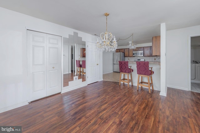 217 Pratt Ct, Sewell, NJ 08080 - kitchen with stainless steel appliances, a chandelier, dark wood finished floors, tasteful backsplash, and a peninsula