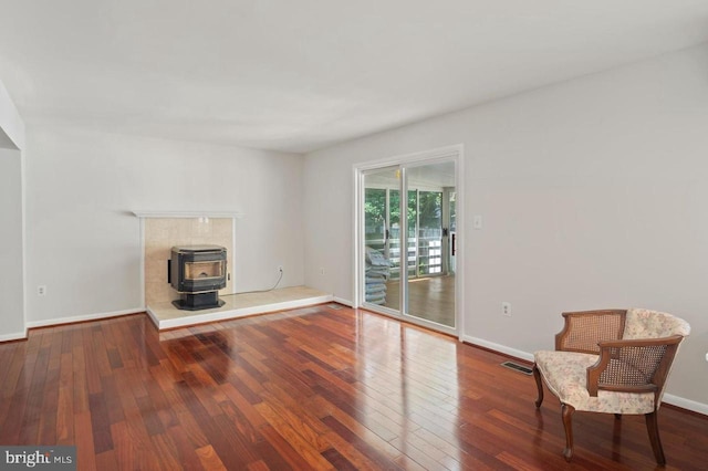 780 Cotswolde Quay Ct, Severna Park, MD 21146 - unfurnished living room featuring a wood stove, hardwood / wood-style floors, and baseboards