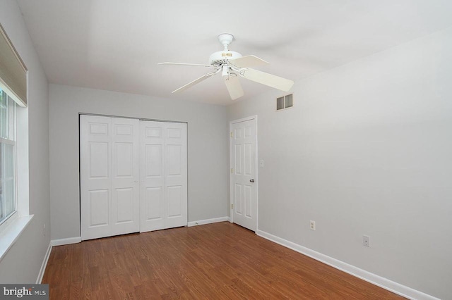 780 Cotswolde Quay Ct, Severna Park, MD 21146 - unfurnished bedroom with baseboards, wood finished floors, a closet, and multiple windows