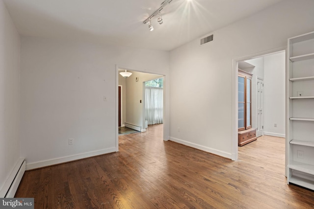 6802 Nesbitt Pl, Mclean, VA 22101 - unfurnished room with a baseboard radiator, wood finished floors, rail lighting, and baseboards