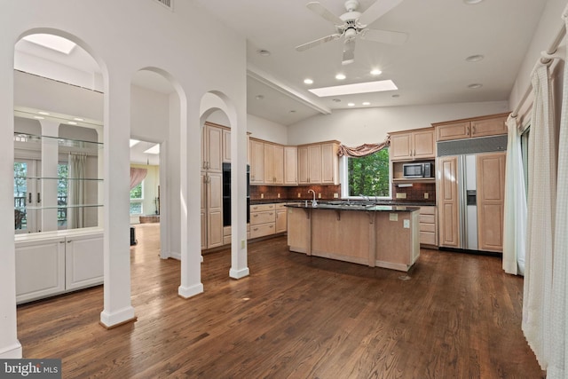 6802 Nesbitt Pl, Mclean, VA 22101 - kitchen featuring paneled built in refrigerator, dark countertops, an island with sink, stainless steel microwave, and decorative backsplash