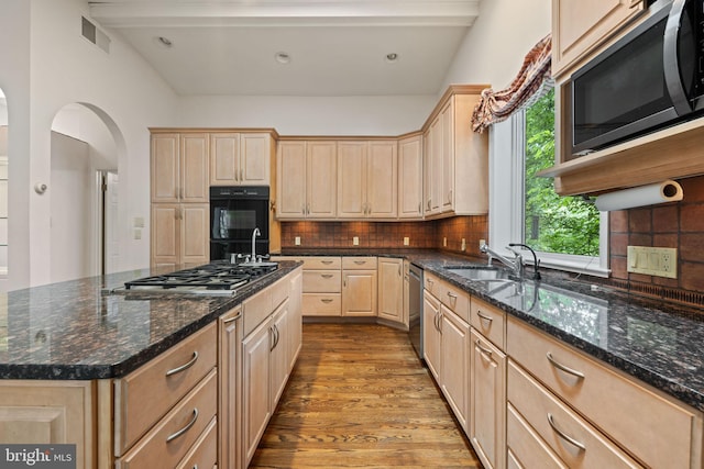 6802 Nesbitt Pl, Mclean, VA 22101 - kitchen with stainless steel appliances, light brown cabinets, a sink, wood finished floors, and arched walkways