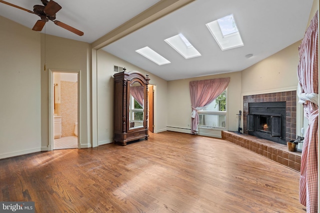 6802 Nesbitt Pl, Mclean, VA 22101 - unfurnished living room featuring lofted ceiling, a fireplace, wood finished floors, a skylight, and a baseboard radiator