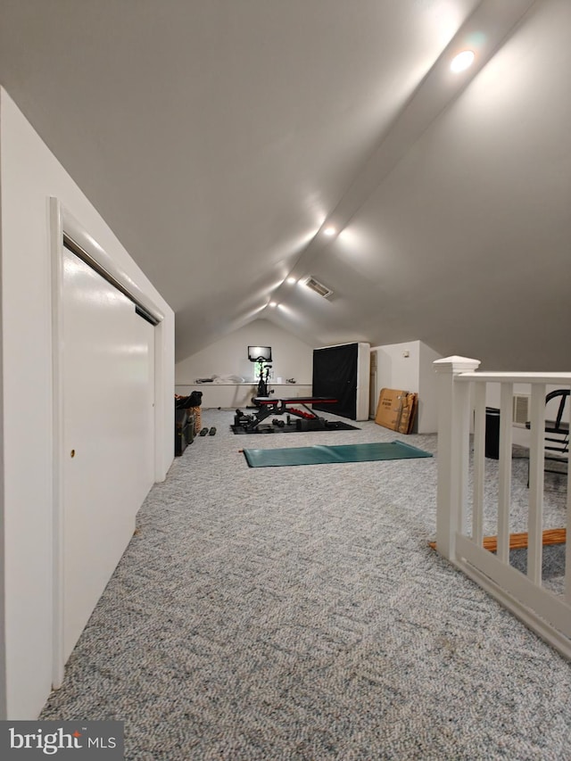 additional living space featuring lofted ceiling and carpet