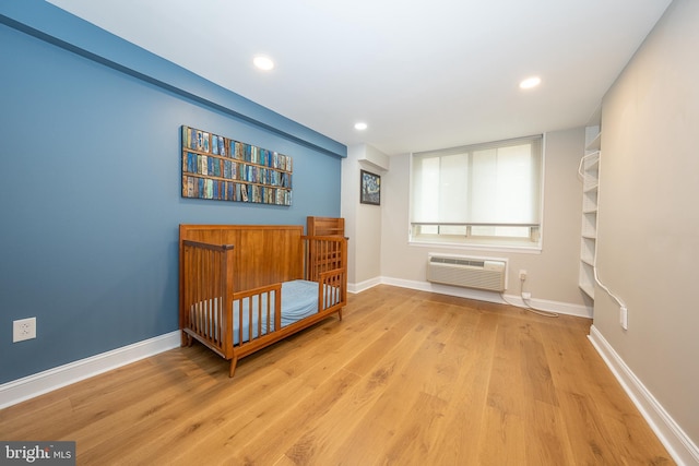1919 Chestnut St Unit 523-524, Philadelphia, PA 19103 - bedroom with a wall unit AC, wood finished floors, baseboards, and recessed lighting