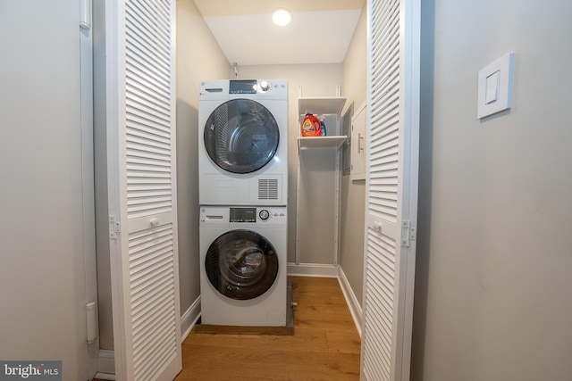 1919 Chestnut St Unit 523-524, Philadelphia, PA 19103 - laundry room featuring stacked washer / drying machine, wood finished floors, and baseboards