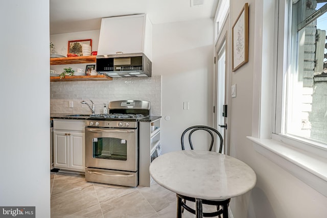 1823 4th St NW, Washington, DC 20001 - kitchen featuring stainless steel appliances, a sink, backsplash, open shelves, and light tile patterned flooring